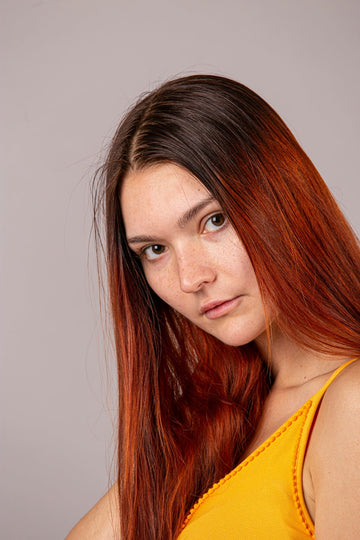 a woman with red hair is posing for a picture